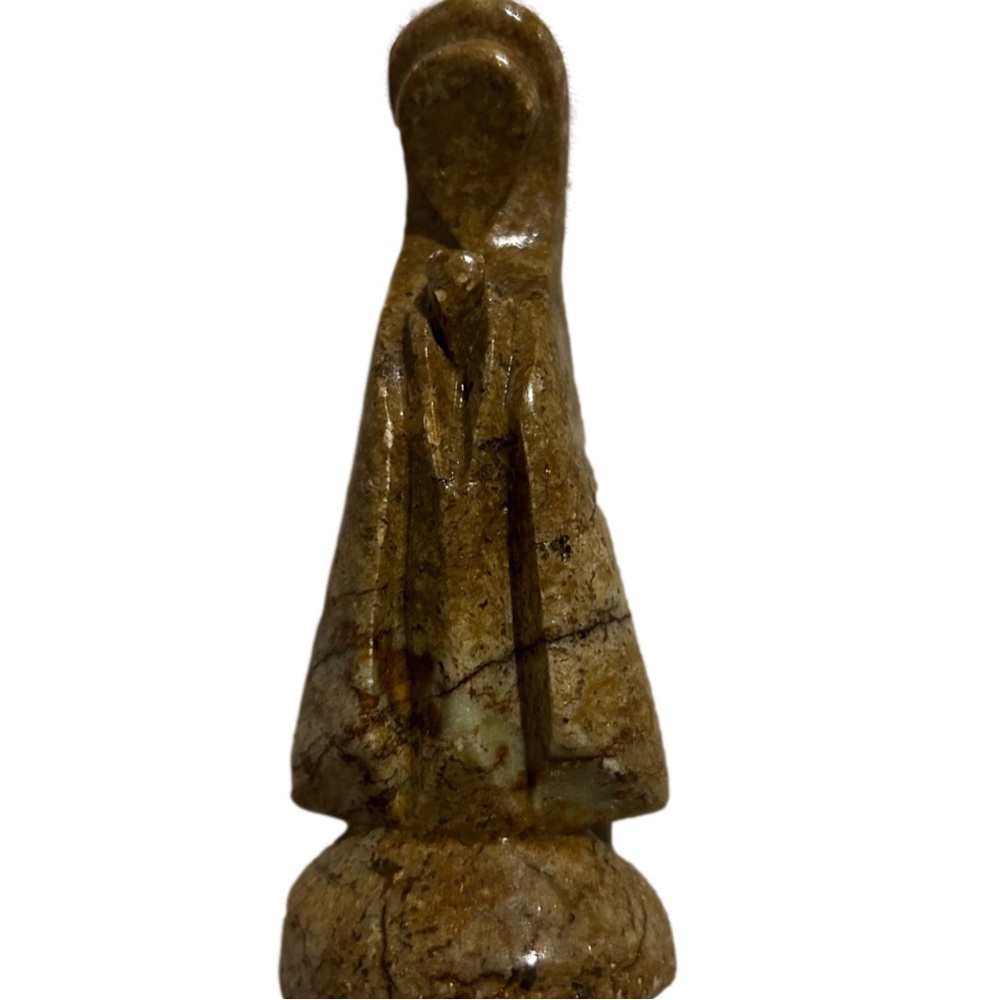 Carved stone figurine, praying Virgin Mary.